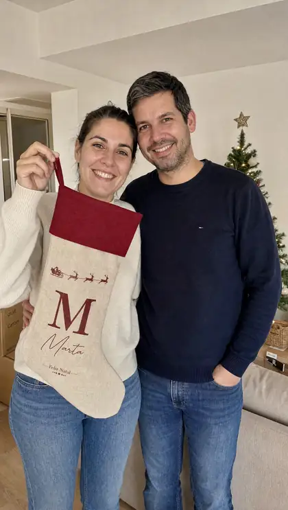 Um casal com uma meia de Natal personalizada
